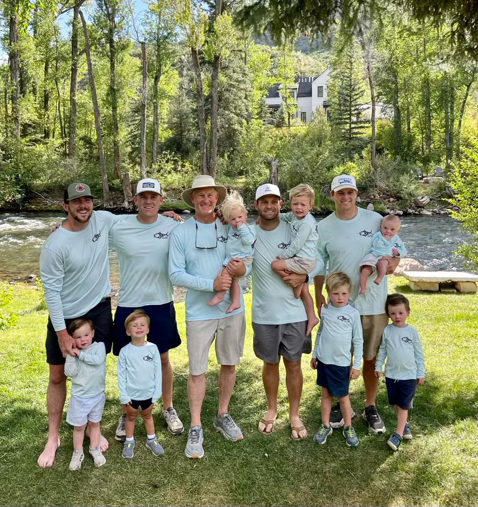 Family group photo in Rainbow Trout UPF 50+ Shirts, showing front logo design and activewear style for coordinated outdoor apparel. fishing family