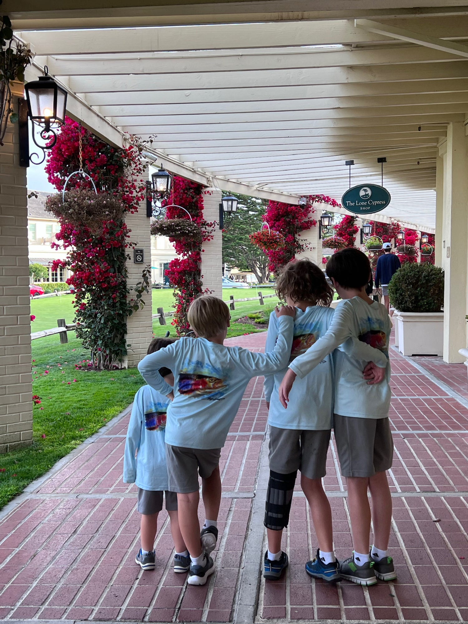 Four kids walking arm-in-arm in Rocky Rainbow Trout Kids Performance Fishing Shirts, combining comfort, style, and UPF 50+ protection for travel.