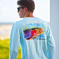 Man wearing Rainbow Trout UPF 50+ Shirt on a balcony, highlighting the artistic trout print and lightweight activewear fit.