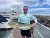 Man holding large fish at marina in Rainbow Trout UPF 50+ Shirt, showing front logo and ideal fit for fishing performance wear.