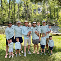 Family group photo in Rainbow Trout UPF 50+ Shirts, showing front logo design and activewear style for coordinated outdoor apparel. fishing family