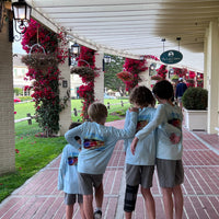 Four kids walking arm-in-arm in Rocky Rainbow Trout Kids Performance Fishing Shirts, combining comfort, style, and UPF 50+ protection for travel.