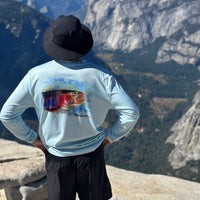 Man overlooking mountain valley in Rainbow Trout UPF 50+ Shirt, emphasizing sun protection and scenic outdoor performance wear.