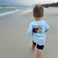 Young boy walking on beach in Rocky Rainbow Trout Kids Performance Fishing Shirt, designed for sun protection and moisture-wicking comfort.